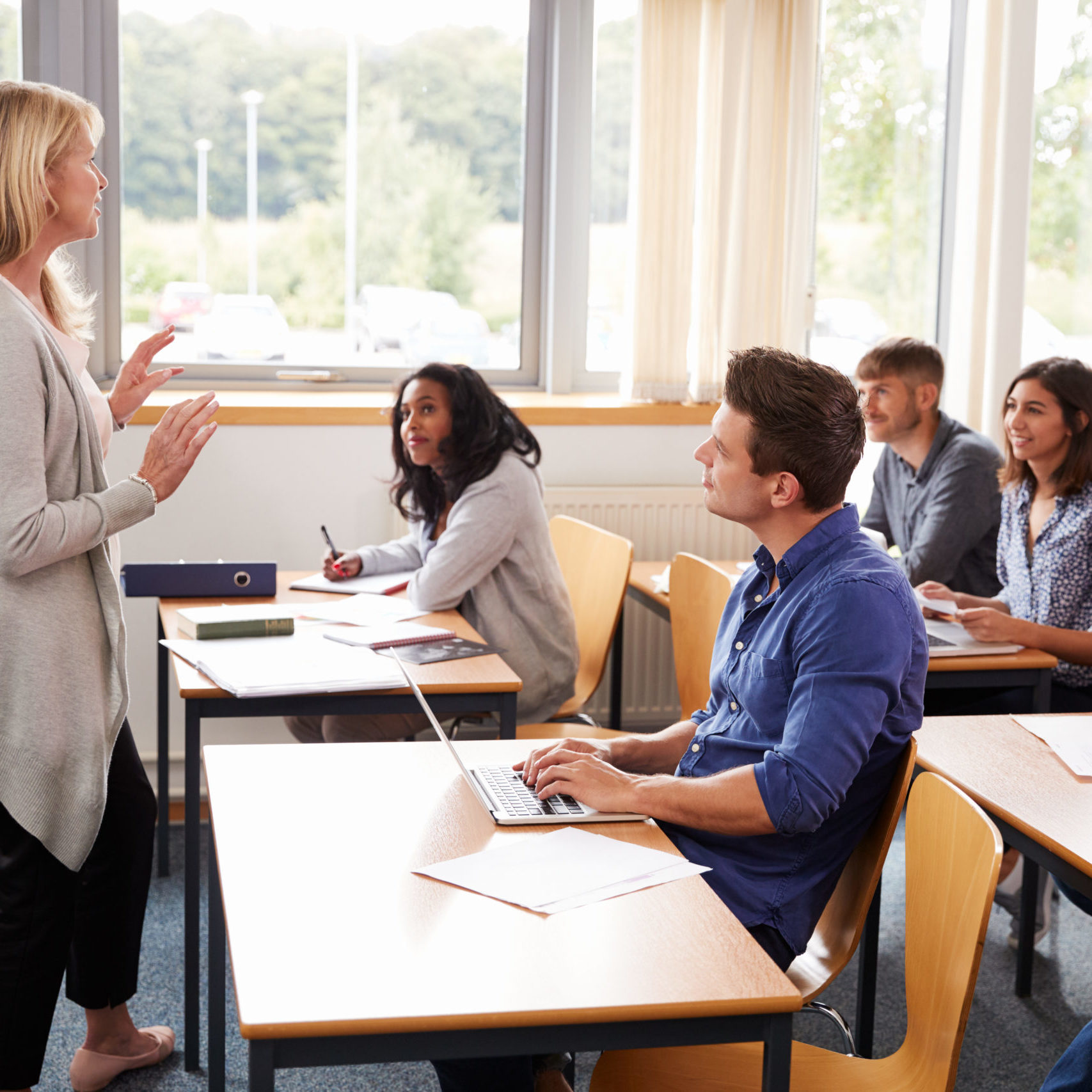 woman teaching a classroom of adults 