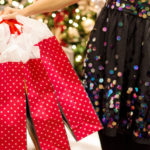 Picture of woman holding red gift bags