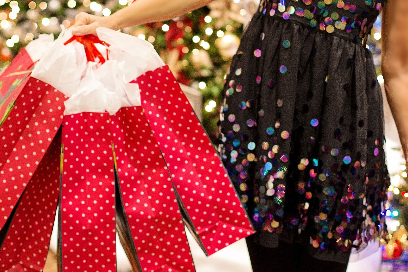Picture of woman holding red gift bags