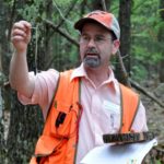 Picture of David Mercker examining a tree
