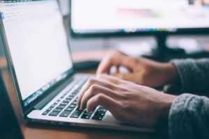 Picture of person typing on a laptop