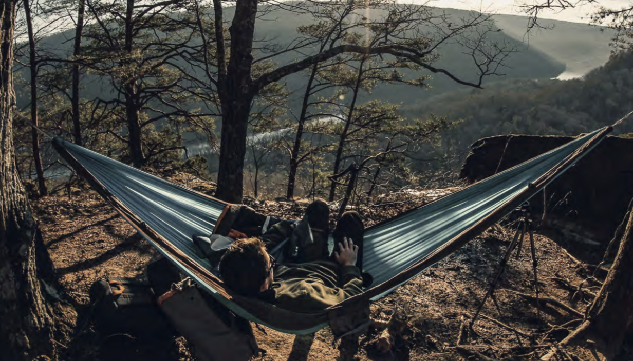 A student lounges in a hammock in the Tennessee mountains